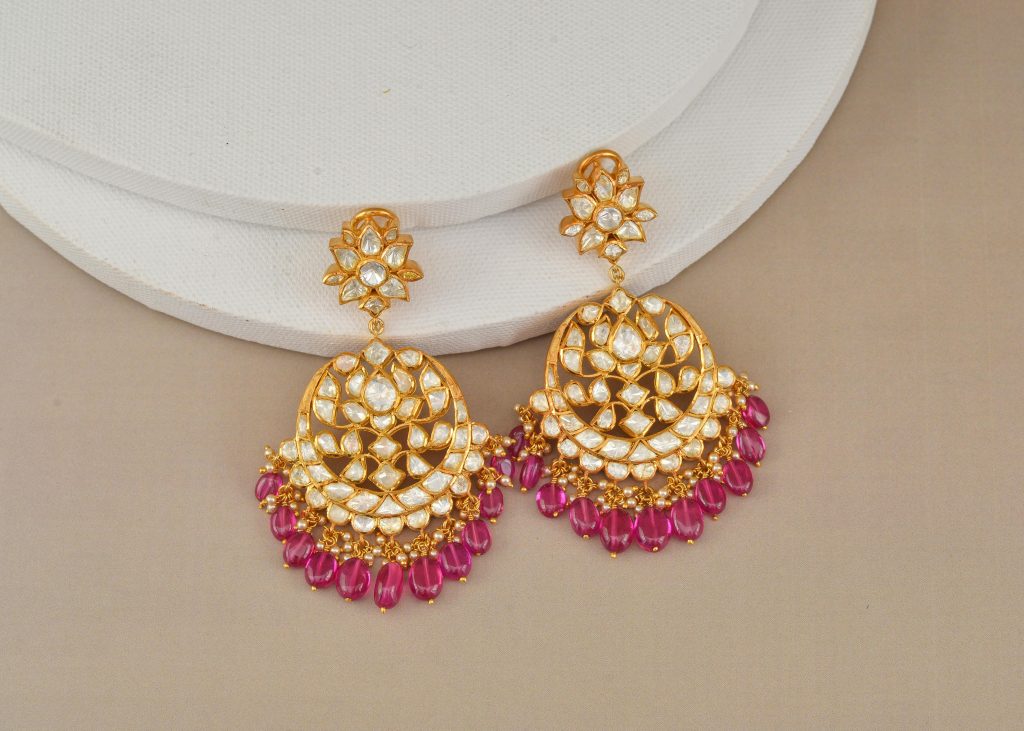 Luxurious gold earrings adorned with diamonds and rubies, perfect for elegant occasions.