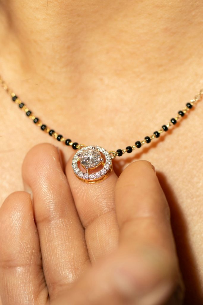 Close-up of a traditional Indian gold and diamond necklace with intricate design and craftsmanship.